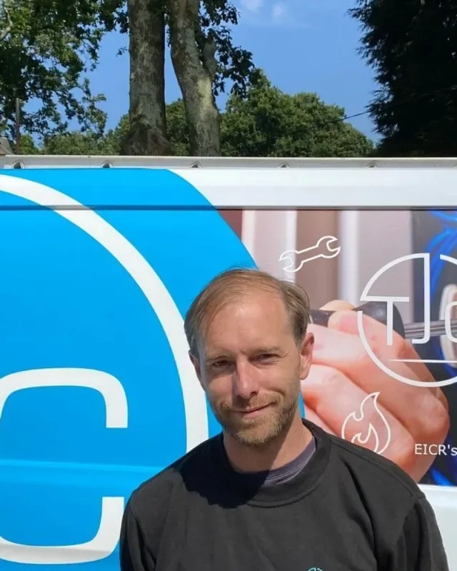 Fraser standing beside a TJC van