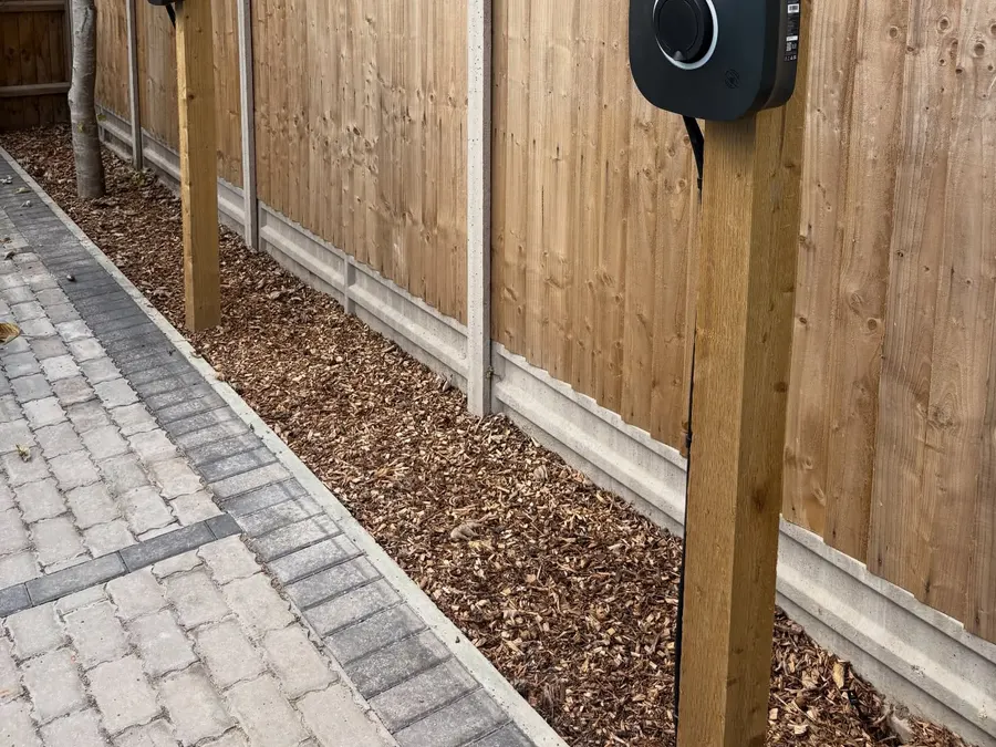 Two Rolec EV chargers mounted on oak posts along a fenced driveway