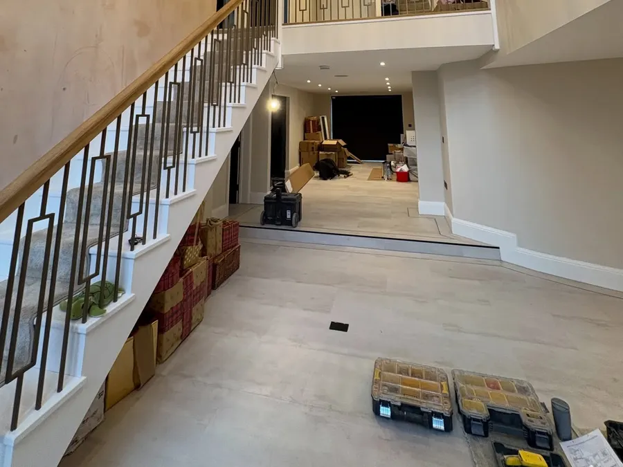 Double-height hallway with glass pendants, oak staircase and downlights