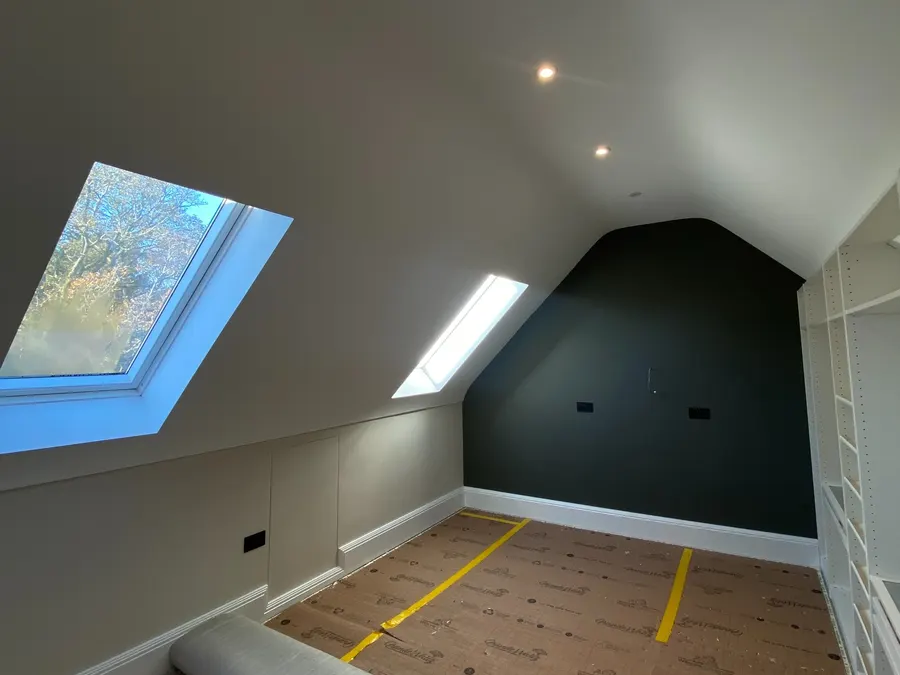 Loft bedroom with recessed downlights and two skylights
