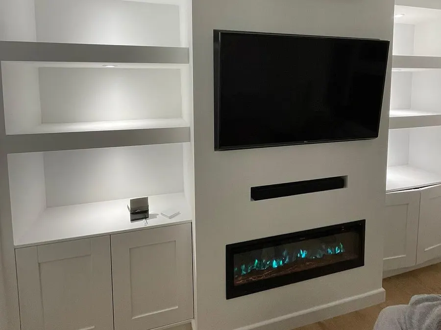 Media wall with television, electric fire and lit shelving niches