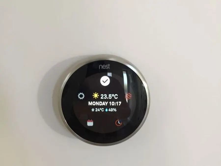 Nest smart thermostat mounted on a wall
