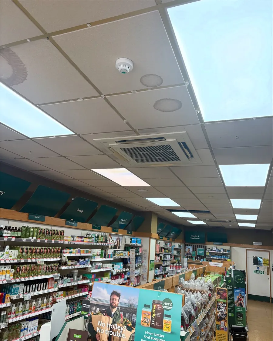 Retail store aisle lit by new recessed LED ceiling panels
